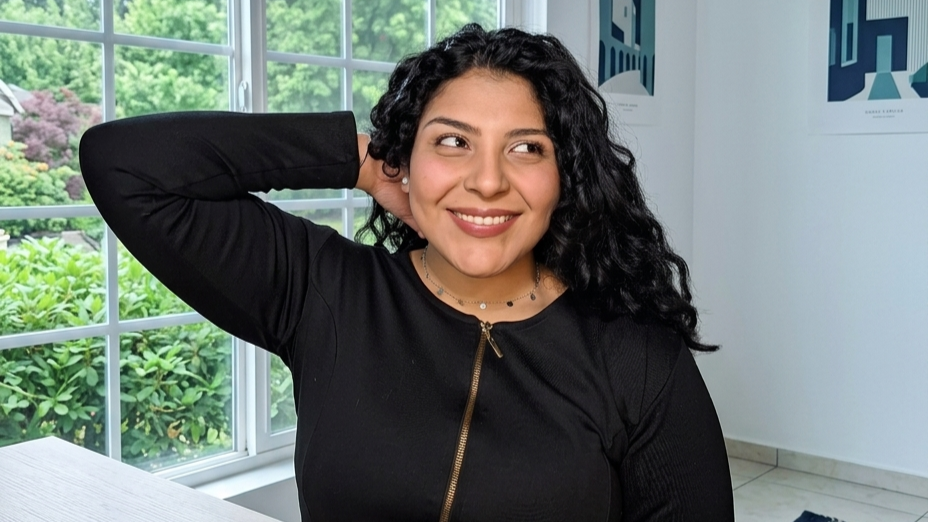 Carylis Palacios In Home Office Leaning Back With Hand In Hair And Mug